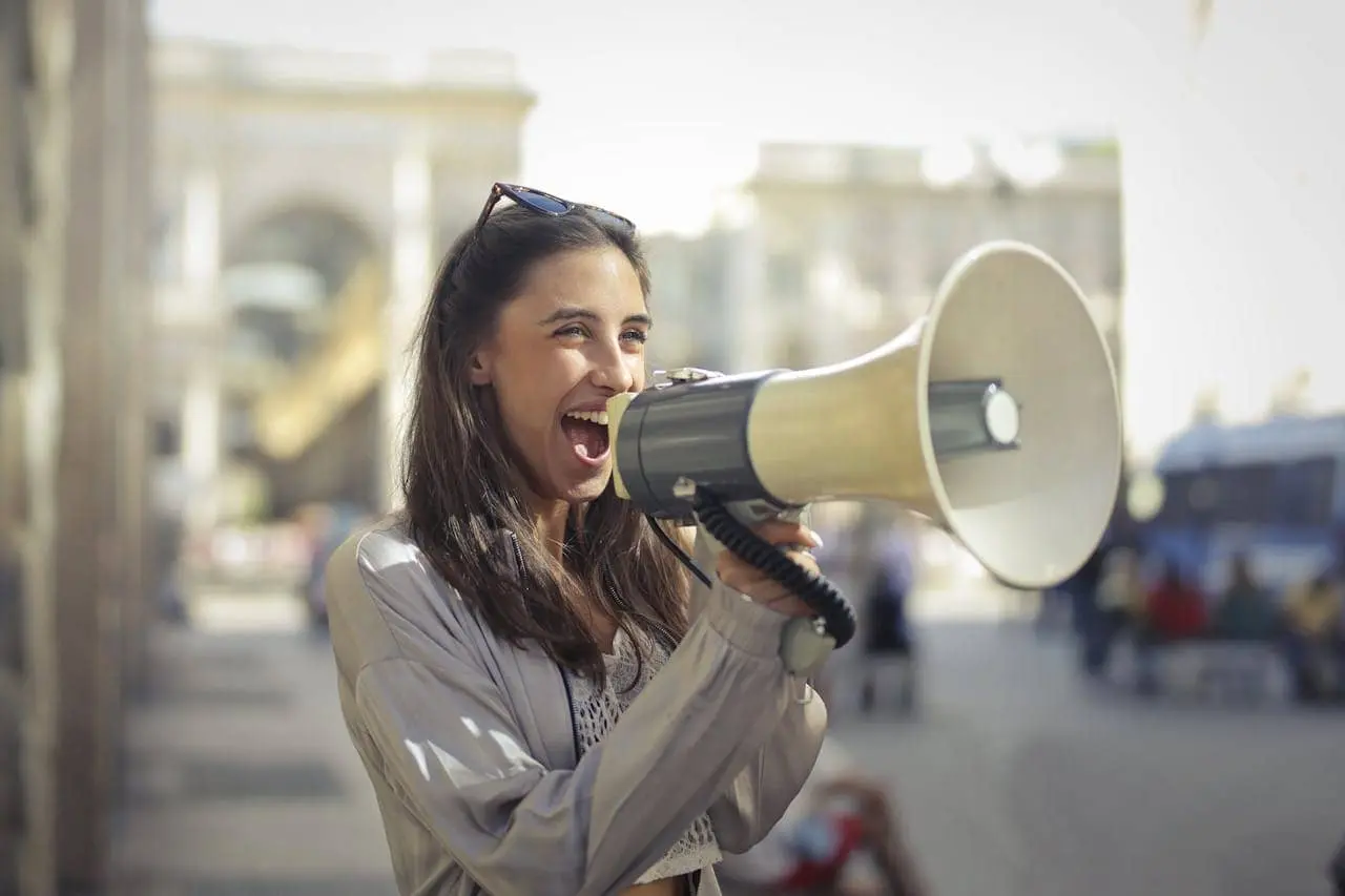 woman holding a megaphone outdoors